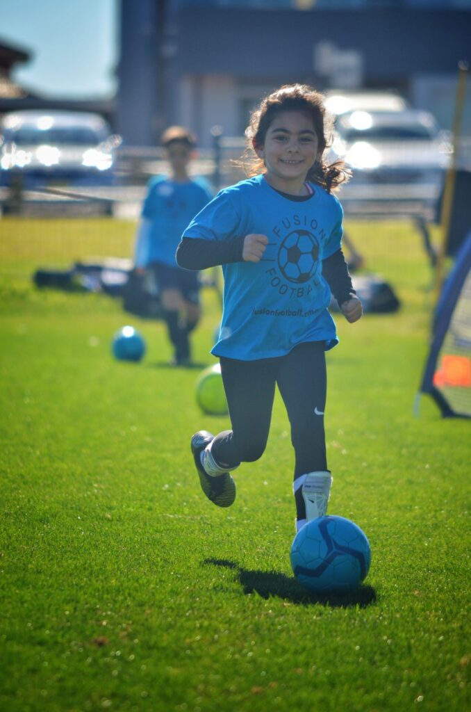 blue mountains soccer skills programs and school holiday workshops fusion football girl kicking a soccer ball