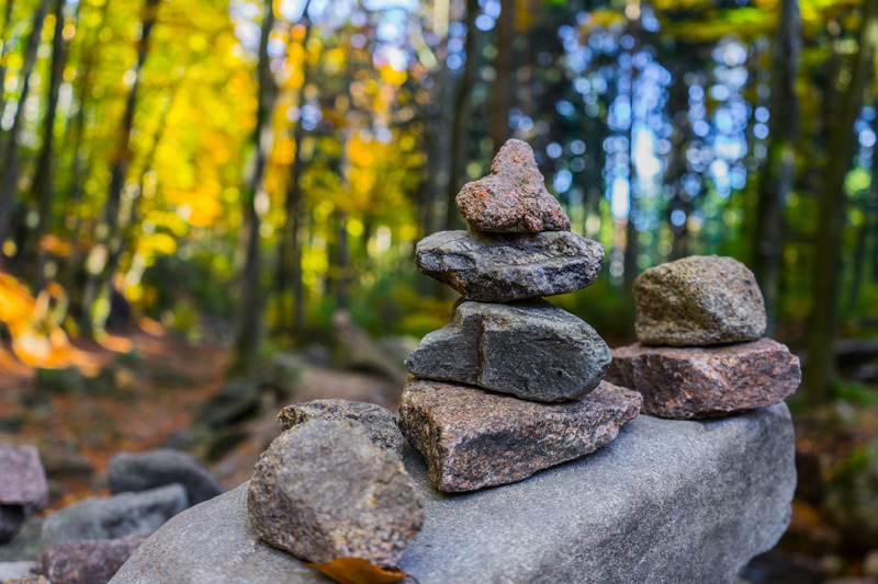 open ended loose parts play with rocks for children at bush playgroup in the Blue Mountains