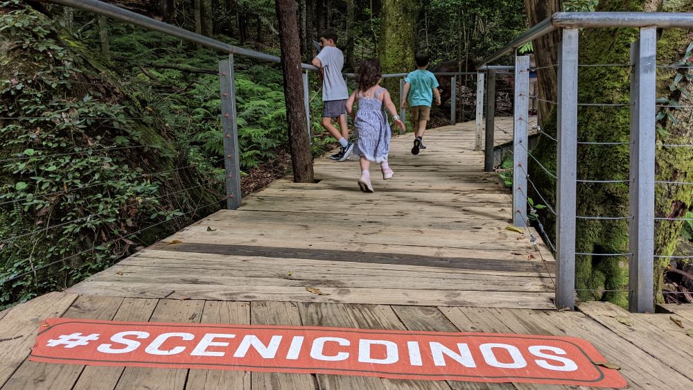 children running into dinosaur valley scenic world