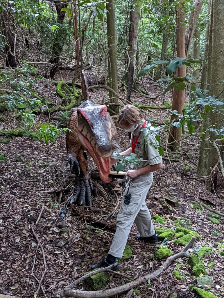 dinosaur ranger brushing a dinosaur's teeth at dinosaur valley scenic world