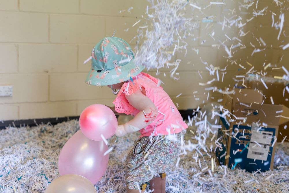 mountain kids sensory play blue mountains playgroup little kid playing with balloons and shredded paper