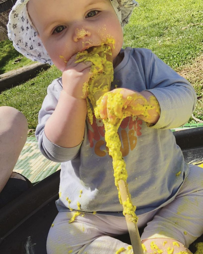 mountain kids sensory play baby eating yellow edible slime