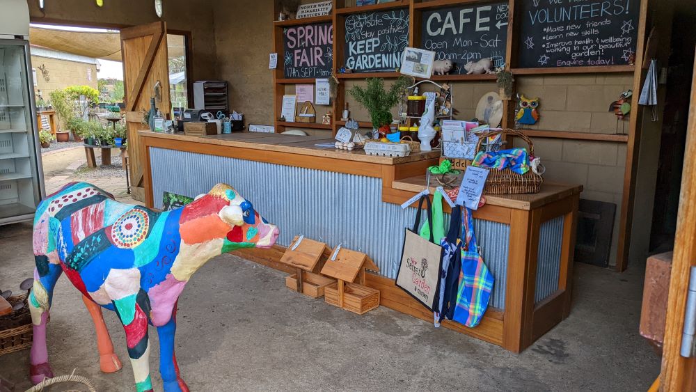 the secret garden and nursery richmond front desk and colourful painted cow statue
