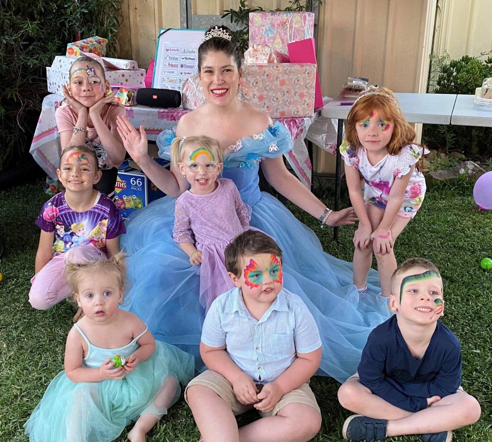 rainbow children's entertainment blue mountains party provider fairy surrounded by children with their faces painted