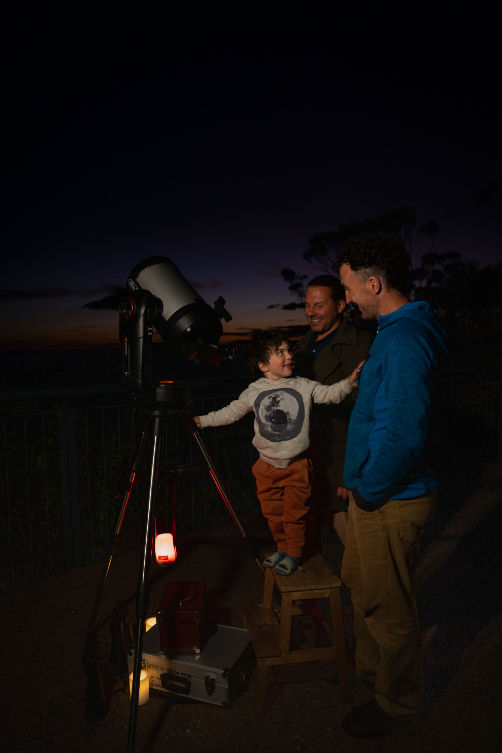 Blue Mountains Stargazing birthday party provider little boy looking at the night sky with his Dad through a telescope