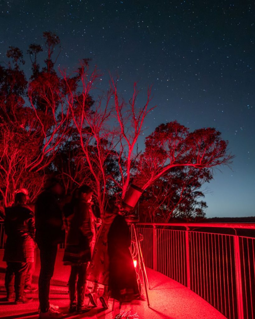 This is a family looking through the telescope at the starry night. Photo taken by Zo Martin Photos. Zo is a local Blue Mountains landscape, nature and street photographer.