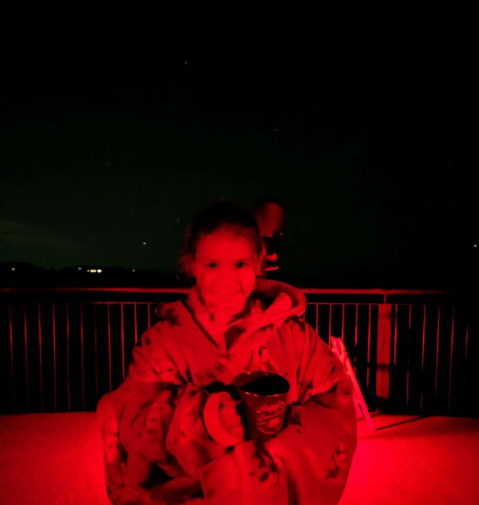 Blue Mountains Stargazing tour welcomes children. This is a little girl in an Oodie holding an oat hot chocolate.