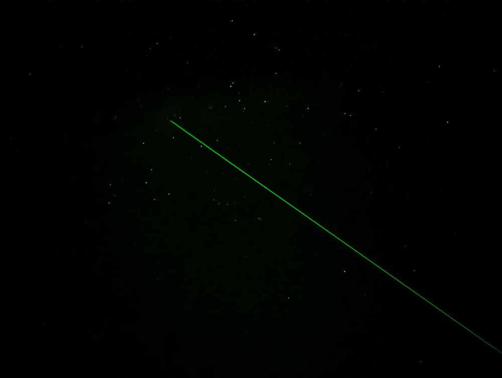 A green laser pointer pointing to the black hole on a Blue Mountains Stargazing tour in Wentworth Falls