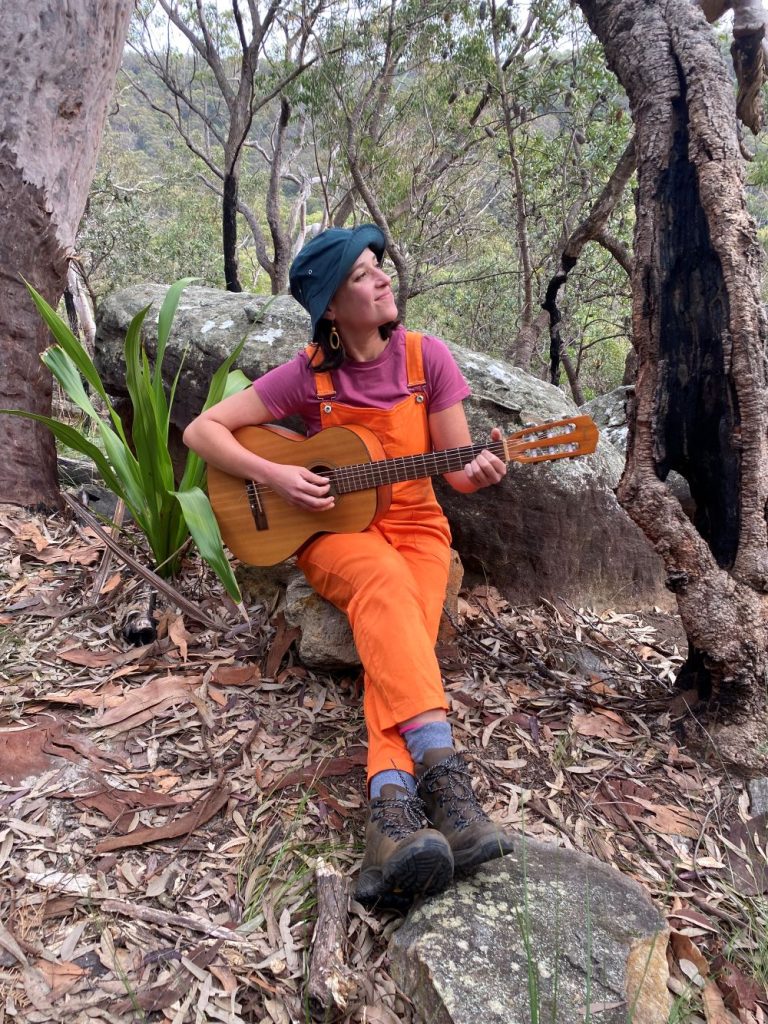 nikki noodle music classes katoomba nikki is playing guitar in the bush