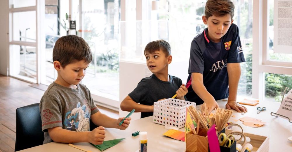 three boys enjoying art and craft at penrith regional gallery's school holiday workshop